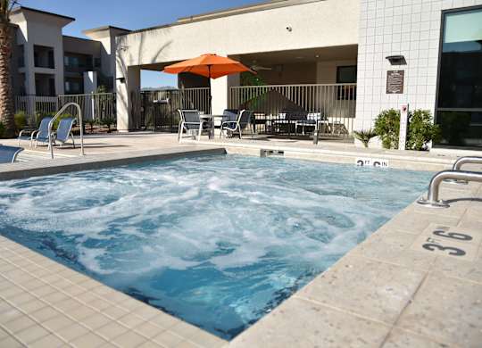 A pool with a hot tub in the middle of it.