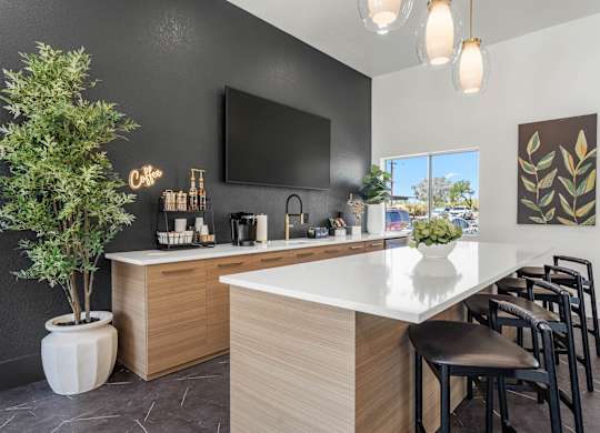 A modern kitchen with a white countertop and wooden cabinets.