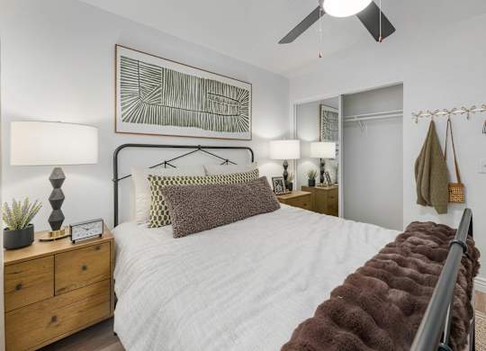 A bedroom with a white bed and a brown headboard.
