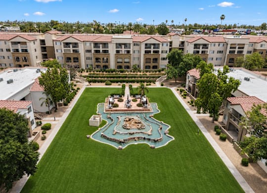 A courtyard with a fountain surrounded by buildings.