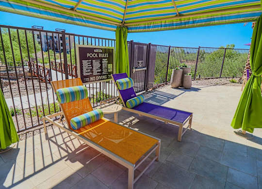 A pool area with a sign that says "POOL RULES" and a "NO DIVING" sign.