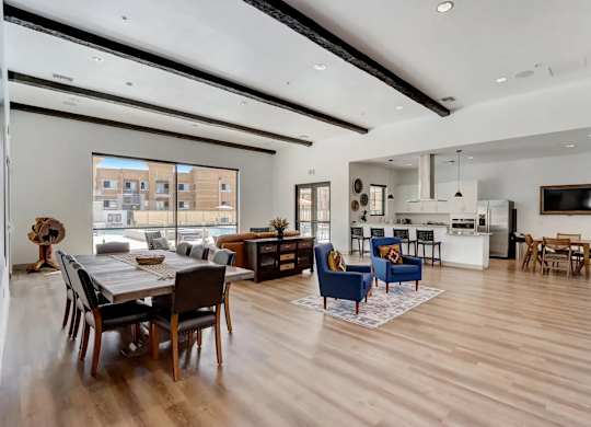A modern open plan living and dining room with wooden floors and furniture.