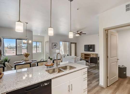 A kitchen with a dining table and chairs.