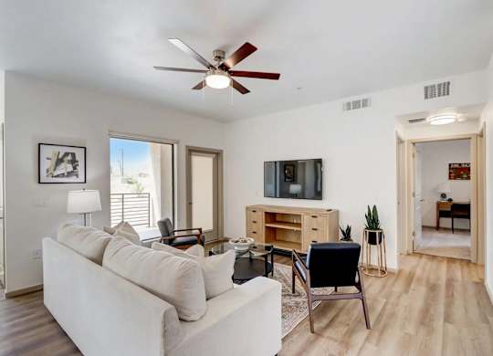 A living room with a white couch and a television.