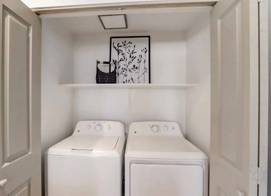 A small laundry room with two washing machines.