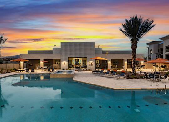 A modern house with a pool in the foreground.