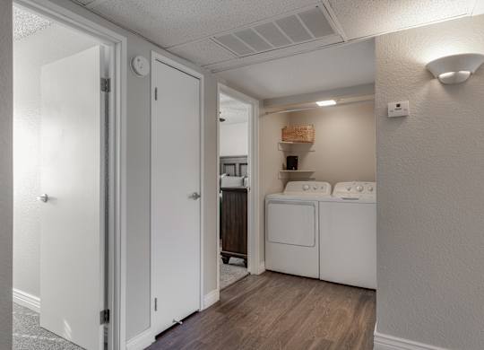A kitchen with white appliances and cabinets is shown.