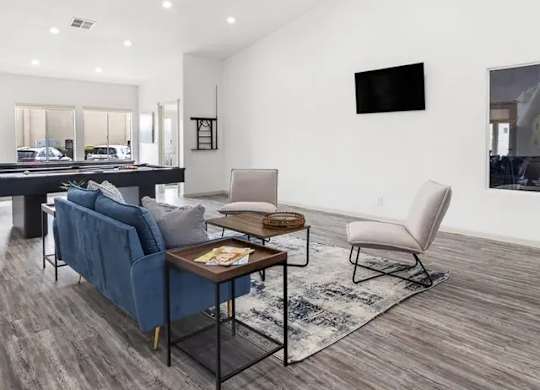 A modern living room with a blue sofa and a wooden coffee table.