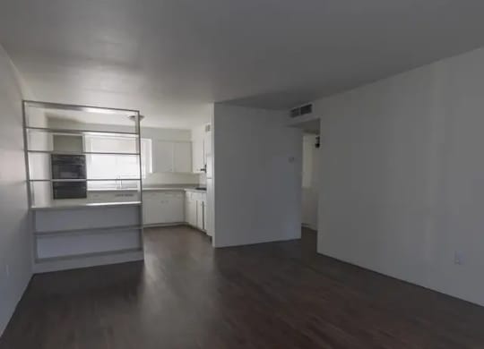 A room with wooden floors and white walls.