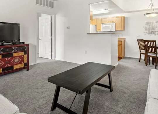 A living room with a black table and a television.