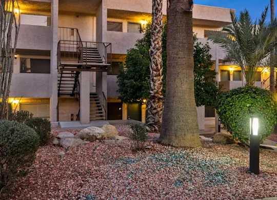 A building with a palm tree in front of it.