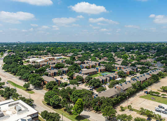 A bird's eye view of a residential area with houses and trees.