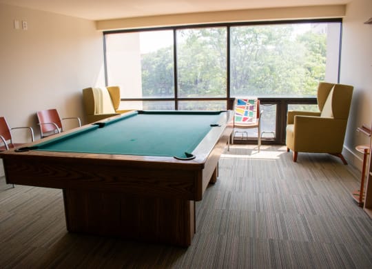 a large room with a pool table and a balcony