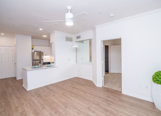Kitchen with white walls and wooden floors at Whitney at the Heights, Houston
