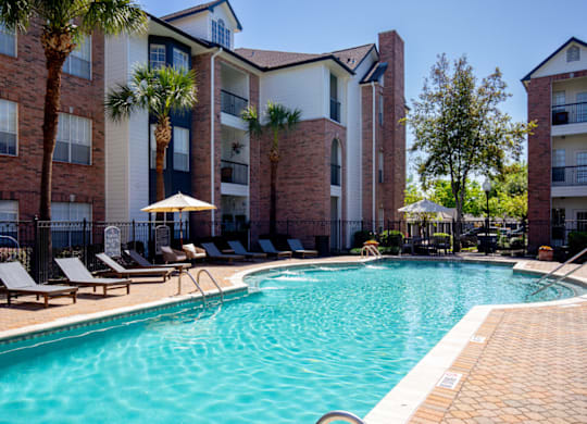 Swimming Pool With Lounge Chairs at Whitney at the Heights, Texas