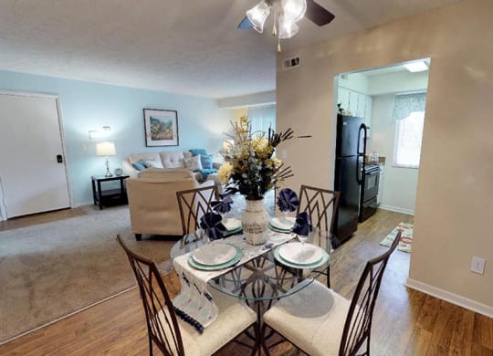 an open living room and dining room with a table and chairs  at Hunter's Creek Apartments, Ohio