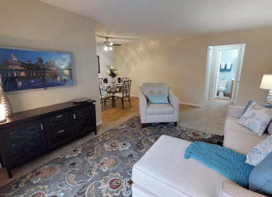a living room with a couch and a chair and a rug  at Hunter's Creek Apartments, Ohio, 45242