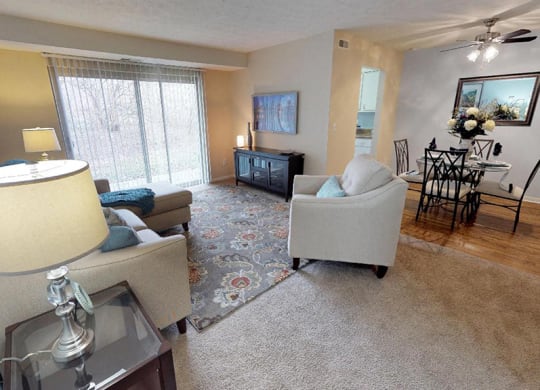 a living room with a couch and a table  at Hunter's Creek Apartments, Cincinnati