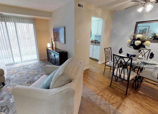 a living room and dining room with a table and chairs  at Hunter's Creek Apartments, Cincinnati, OH