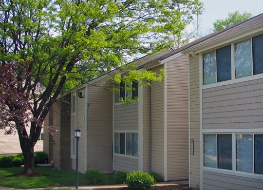 a side view of an apartment building with a tree  at Hunter's Creek Apartments, Cincinnati