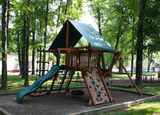 a swing set with a slide in a park  at Hunter's Creek Apartments, Cincinnati, OH, 45242