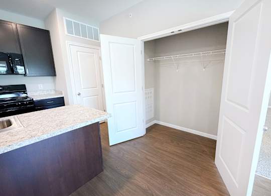 A kitchen with a counter top and a white door.