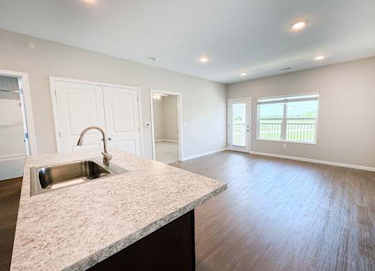 A kitchen with a sink and a window.