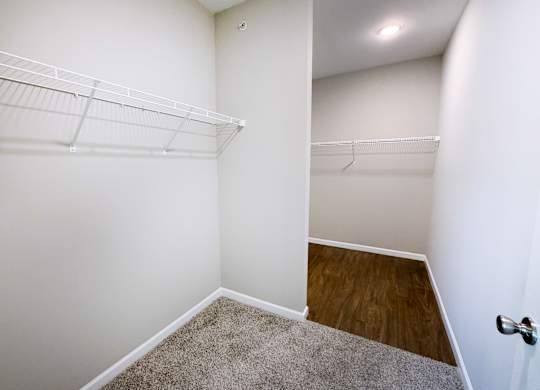 Empty room with white walls and a carpeted floor.