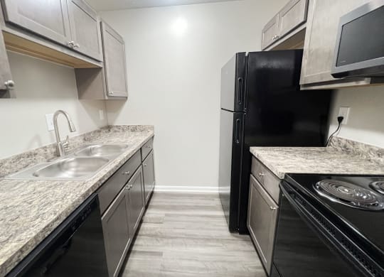 a kitchen with stainless steel appliances and marble counter tops at Revere Village Apartments, Centerville, OH, 45458