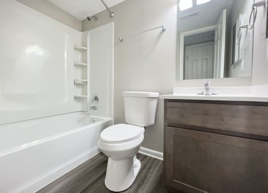 a bathroom with a toilet and a tub and a sink at Revere Village Apartments, Ohio, 45458