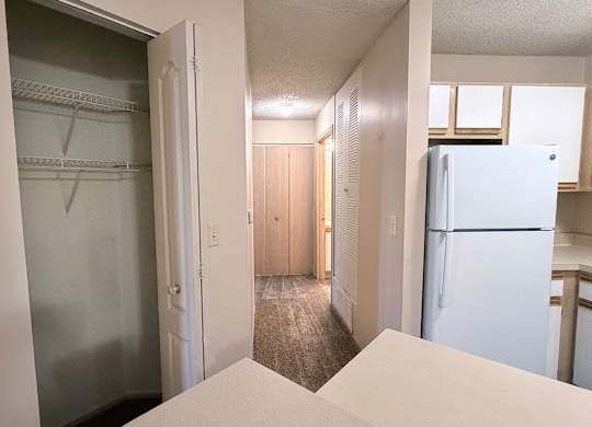 A white refrigerator is in the kitchen.