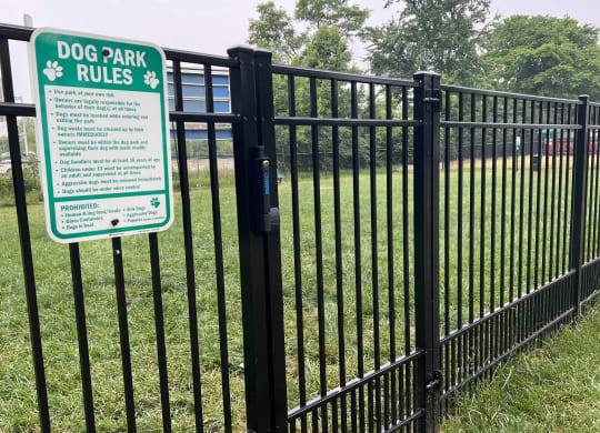a black fence with a sign that says dog park rules  at Hunter's Creek Apartments, Cincinnati, OH, 45242