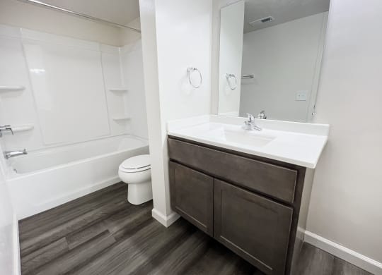 a bathroom with a sink and a toilet and a bath tub at Deercross Apartments, Cincinnati, OH
