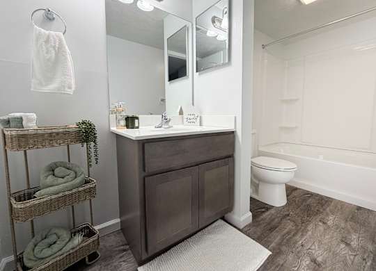 A bathroom with a white toilet and a white bathtub.
