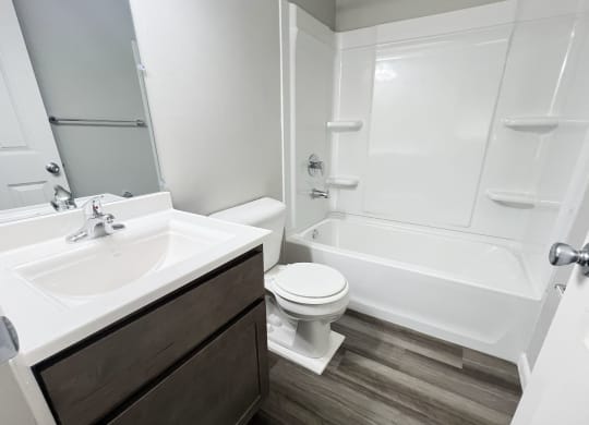 an empty bathroom with a sink toilet and shower at Fox Run Apartments, Cincinnati