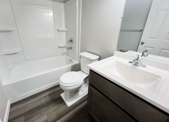 an empty bathroom with a sink toilet and bath tub at Fox Run Apartments, Cincinnati
