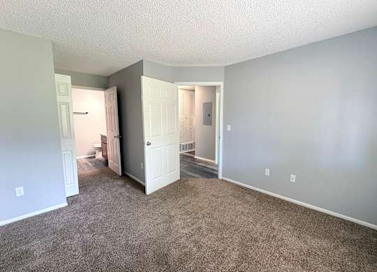 A room with carpeted floor and white walls.