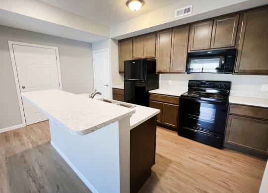 an empty kitchen with an island in the middle of it