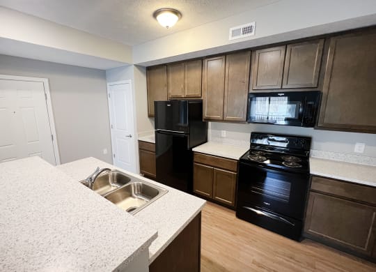 a kitchen with black appliances and white counter tops  at Brookfield Village Apartments, Grove City, OH, 43123