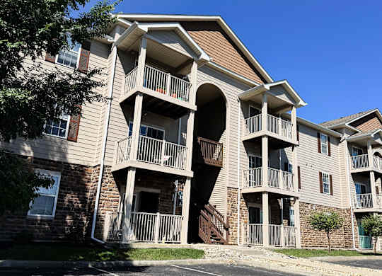 A large apartment building with a balcony on the second floor.