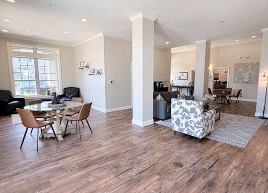 A living room with a dining table and chairs.