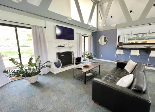 a living room with a black leather couch and a television at Miamisburg by the Mall, Miamisburg, OH, 45342