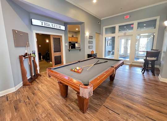 a billiards table in the clubhouse of a home with a pool table