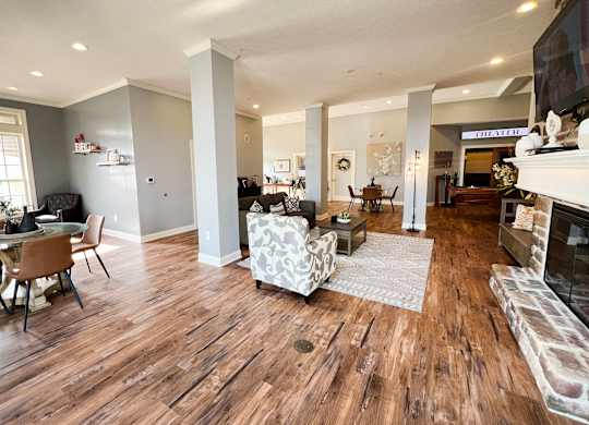 the view of a living room with a fireplace and wooden floors at The Residences at Liberty Crossing, Columbus