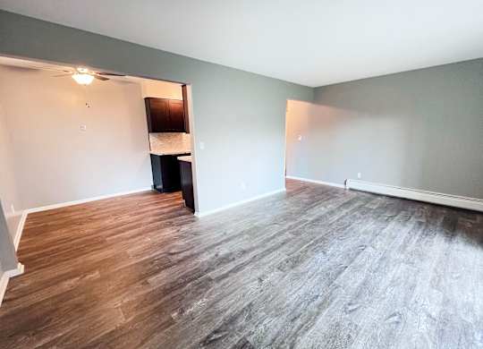 A room with wooden flooring and a white ceiling.