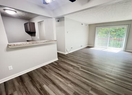 an empty living room with hardwood flooring and a window at Fox Run Apartments, Cincinnati