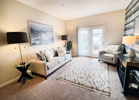 a living room with a couch and a chair and a rug at Liberty Crossing, Columbus, 43235
