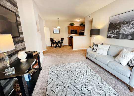 an open living room with a couch and a rug at The Residences at Liberty Crossing, Columbus, Ohio
