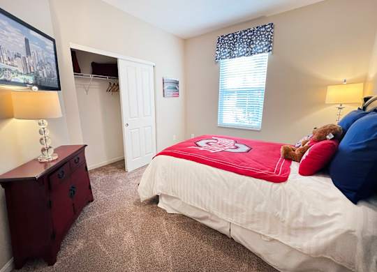 a bedroom with a bed and a teddy bear in it at The Residences at Liberty Crossing, Columbus, OH, 43235