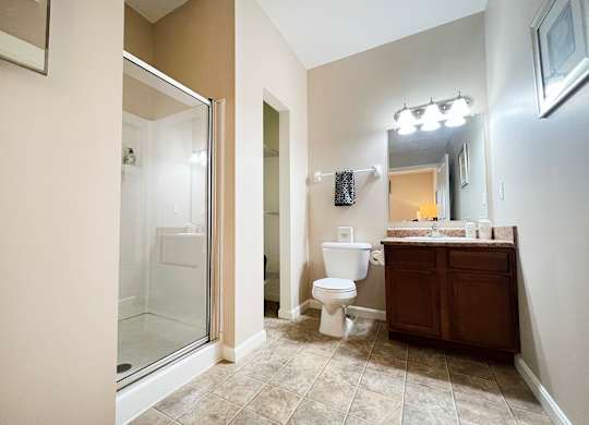 a bathroom with a shower toilet and sink and a mirror at The Residences at Liberty Crossing, Columbus